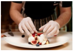 Gloved hand prepping food