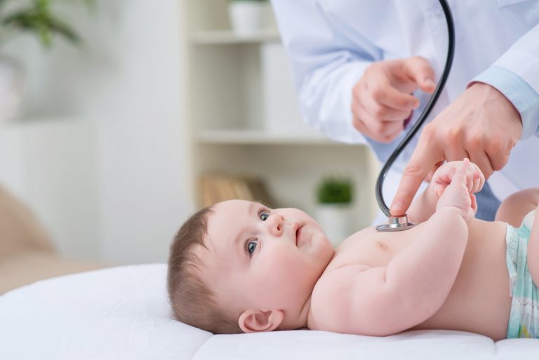 Doctor using a stethoscope on a baby