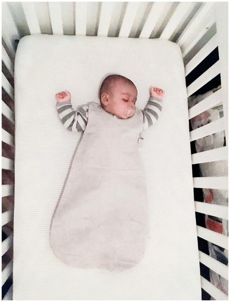 Baby on back in sleep sack