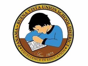 Emblem for Panama-Buena Vista Union School District Excellence in Education with Child with blue sweater sitting while writing in a note book. Since 1875.